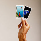 hand holding 2 stickers from the playdate with the Universe tarot deck 