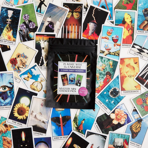 Mini Tarot card stickers scattered on the table with the tarot card mystery packaging on top