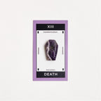 amethyst coffin shaped crystal on white surface