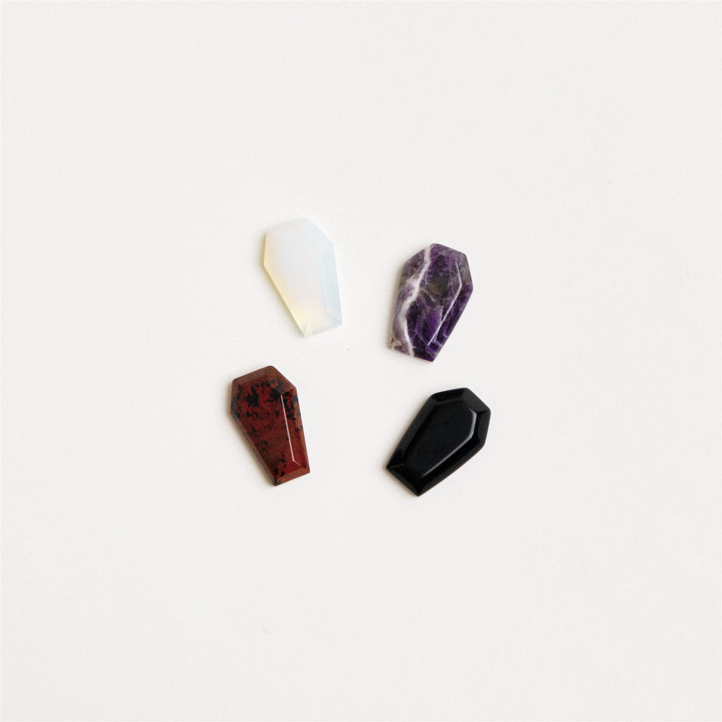 assorted coffin shaped crystals on a white surface