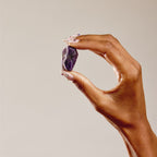 hand holding amethyst coffin shaped crystal