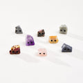 Assortment of crystal pet rocks on a white background