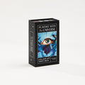 tarot deck box with Playdate with the Universe title, Collage Art Tarot Deck subtitle, Stephanie Gilbert as the author. Card art featured on box with blue iris flower and blue eye collaged in the center