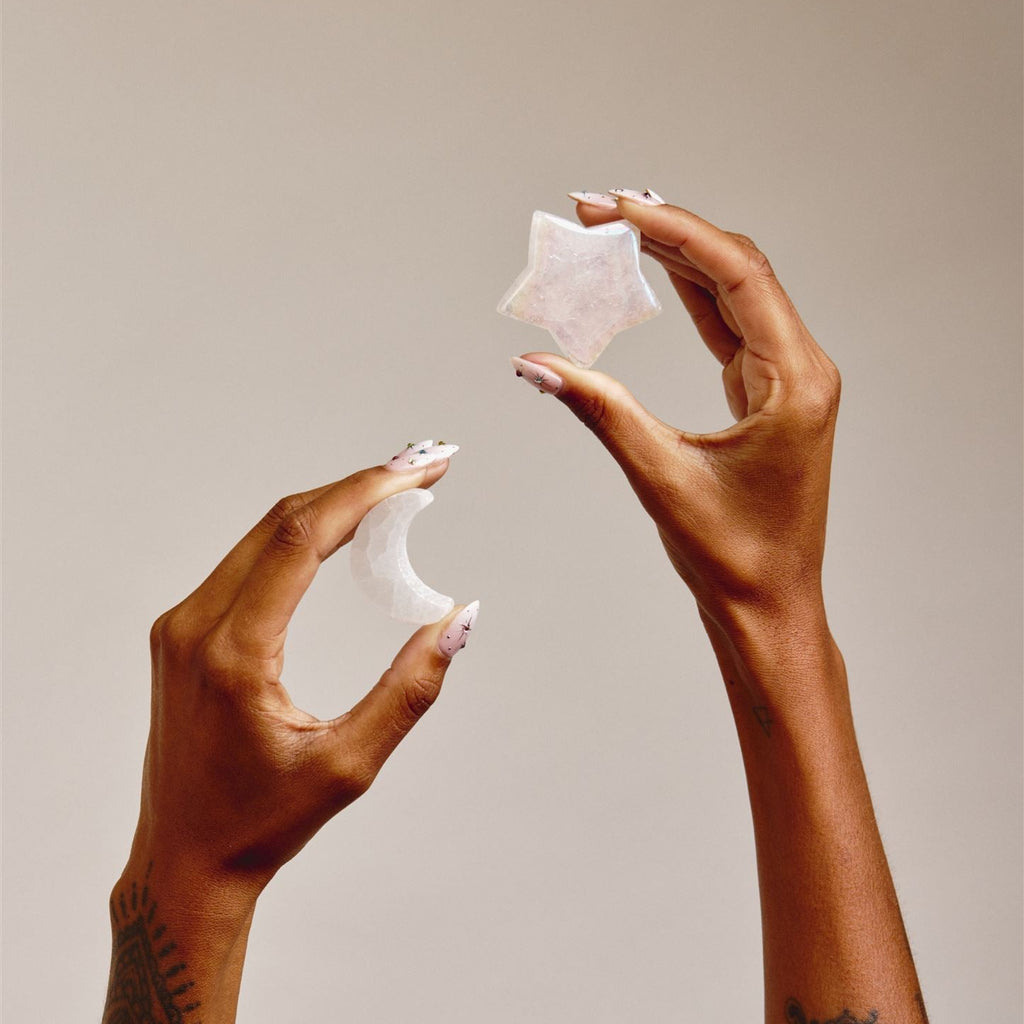 hands holding Star and Moon Shaped crystals 