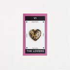 dalmatian jasper heart shaped crystal on white surface