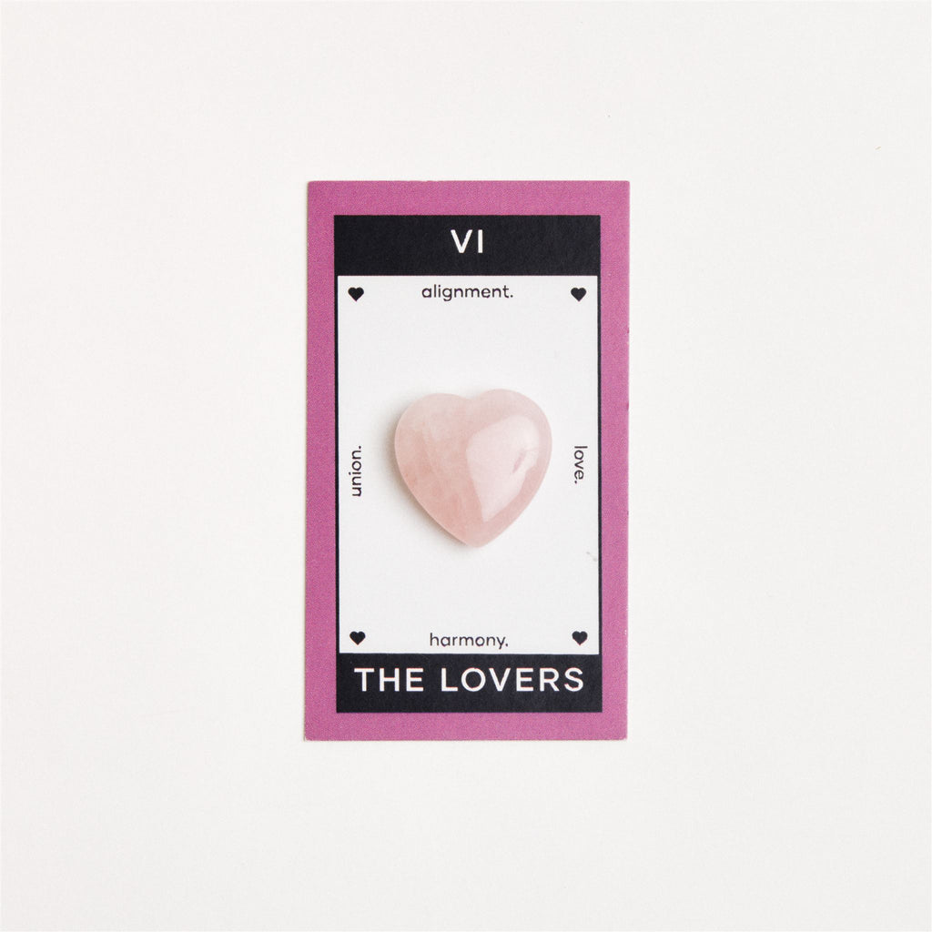 heart shaped rose quartz crystal on white surface