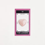 heart shaped rose quartz crystal on white surface