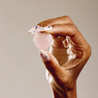 hand holding heart shaped crystal