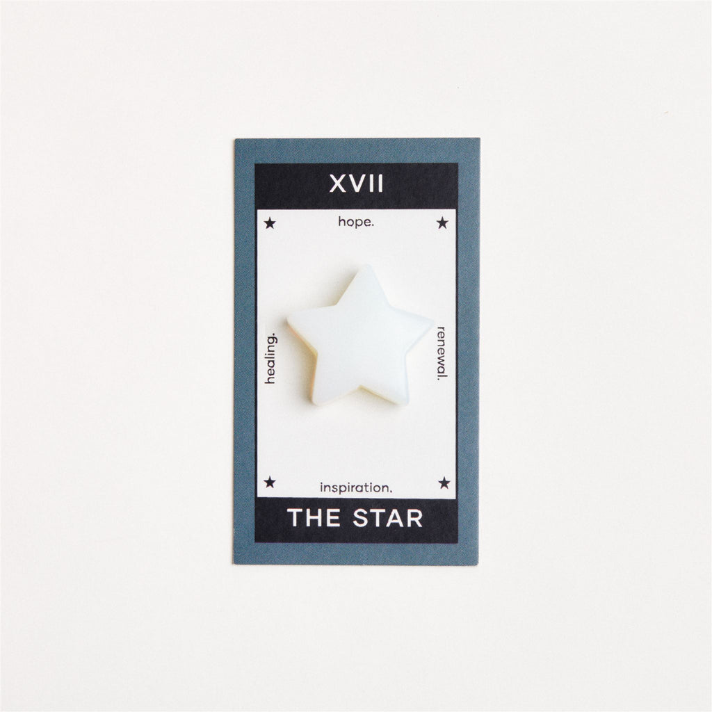 opalite star shaped crystal on white surface