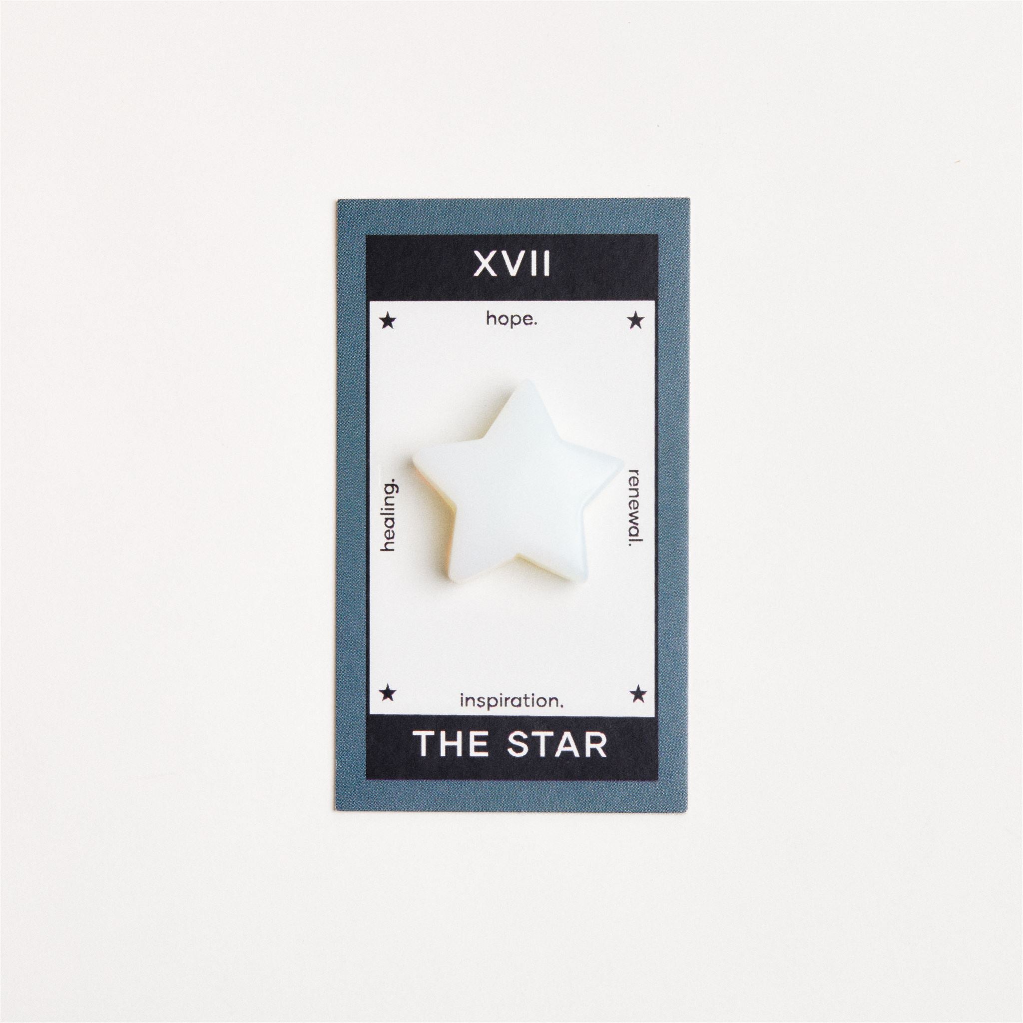 opalite star shaped crystal on white surface
